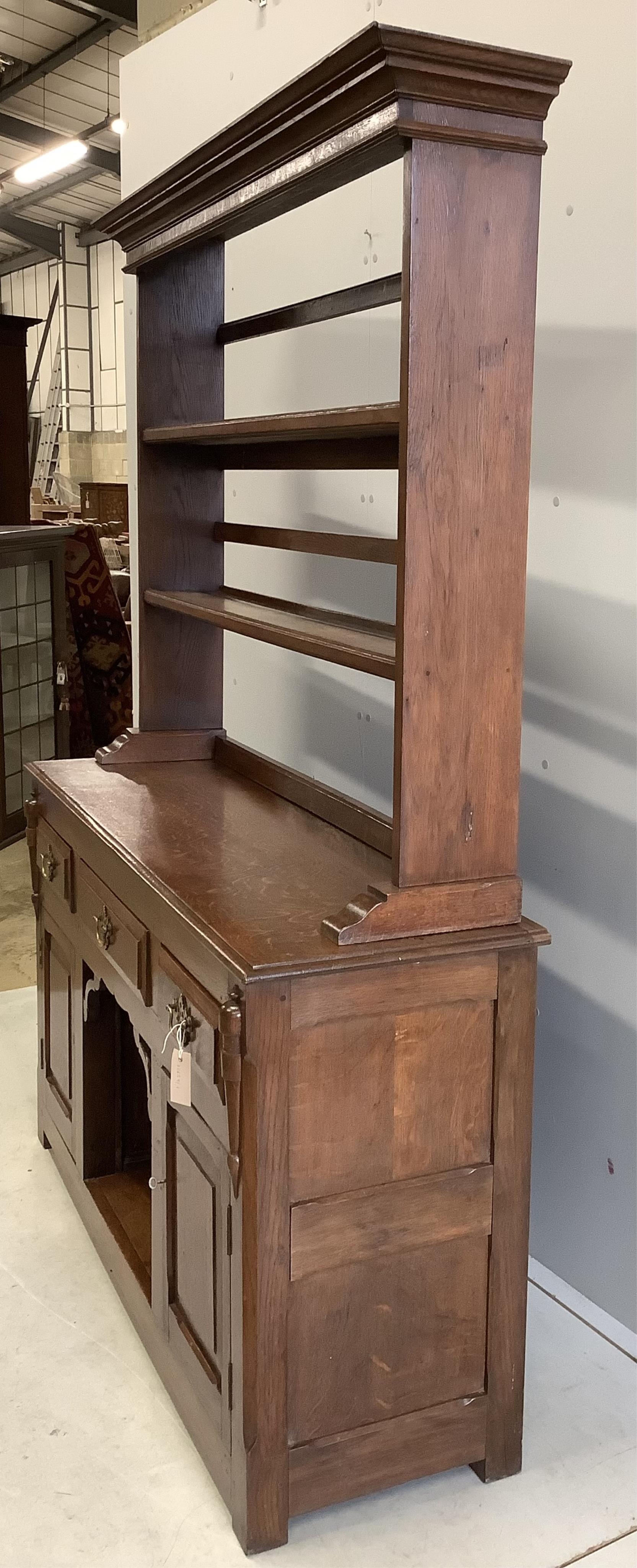 An 18th century style oak 'dog kennel' dresser, with boarded rack, width 138cm, depth 41cm, height 182cm. Condition - fair to good